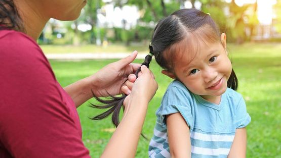 A child speaking to a nursery teacher 